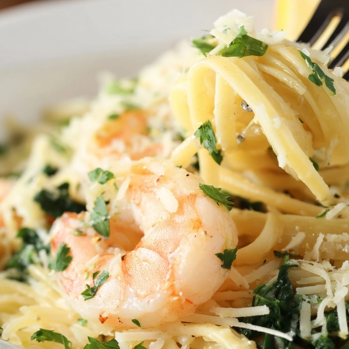 Close-up of Lemon Garlic Shrimp Pasta with Spinach, showcasing plump shrimp and glossy lemon sauce coating every strand.