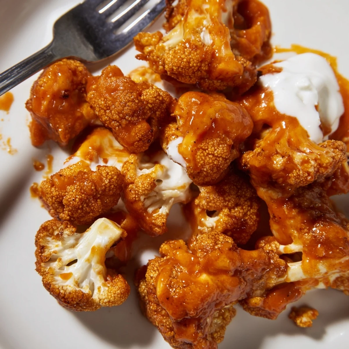 Crispy battered Air Fryer Buffalo Cauliflower Bites tossed in tangy sauce, plated with ranch for an easy game-day snack.