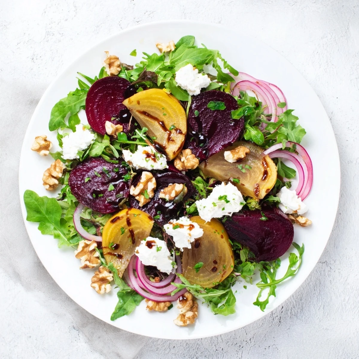 A colorful serving of roasted beet salad topped with crumbled feta and walnuts, perfect alongside grilled chicken or salmon.
