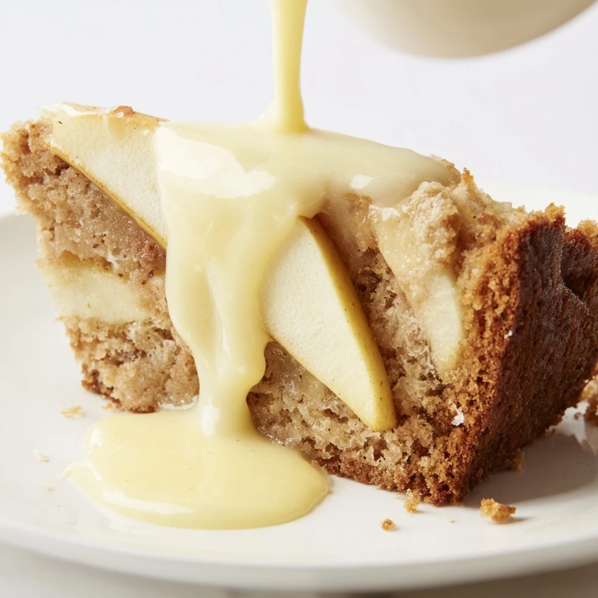 Rustic Irish Apple Cake with Custard Sauce on a wooden board, topped with demerara sugar and paired with steaming tea.