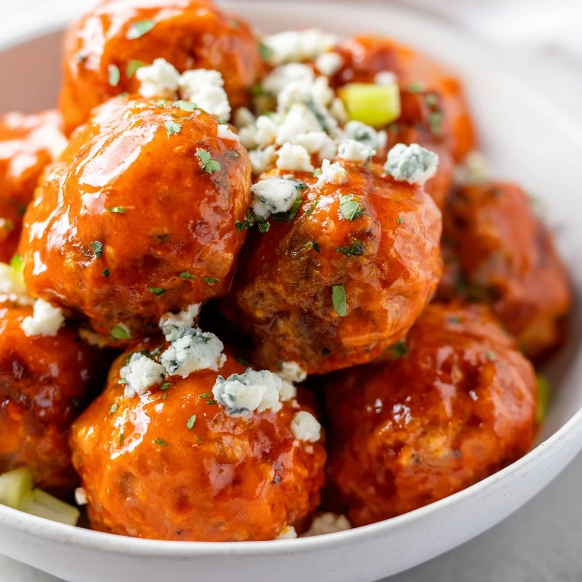 Savory Game Day Spicy Buffalo Chicken Meatballs tossed in buttery hot sauce, perfect for a casual party snack.