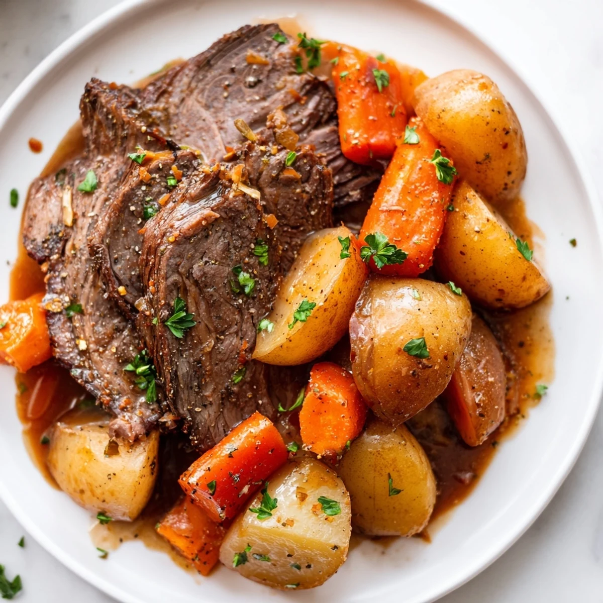 Tender Irish Beef Pot Roast with Carrots and Potatoes, slow-cooked to perfection and served in a rich, savory gravy.