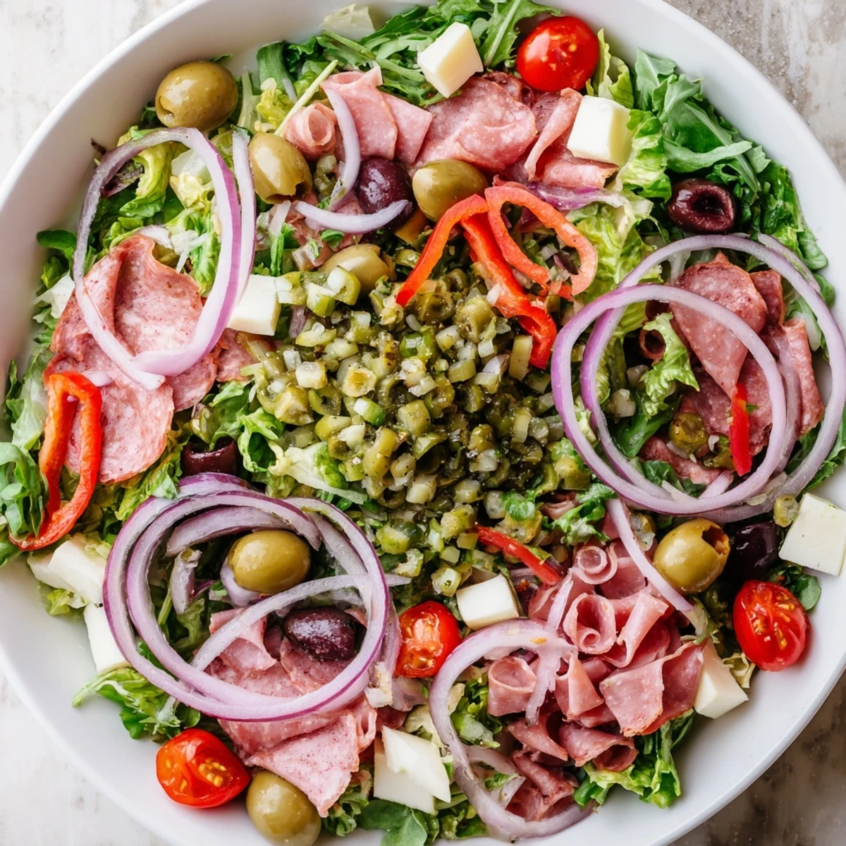 Zesty olive salad recipe served with crunchy bread cubes for an easy gluten-free main dish.