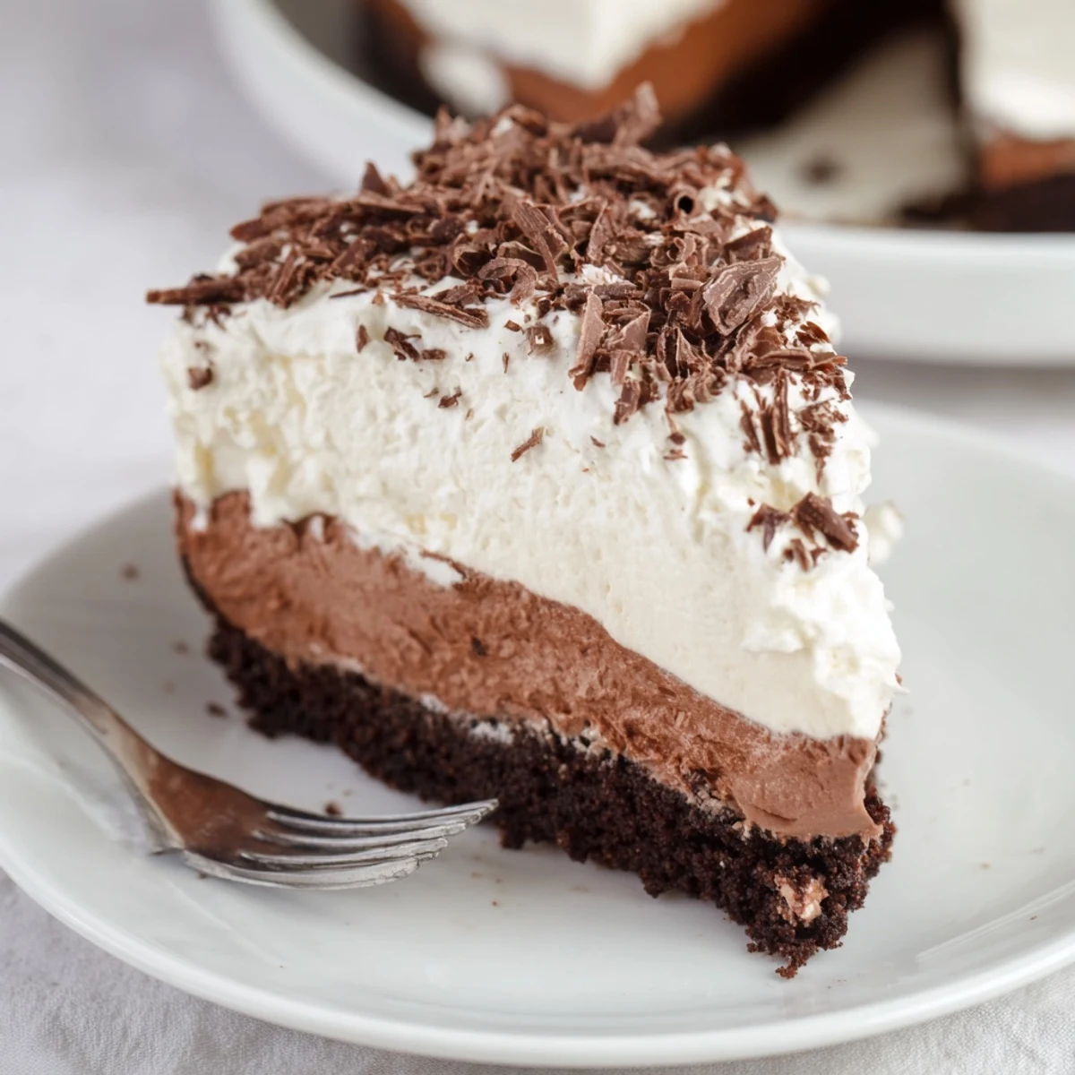 Ready to serve Irish Cream Cheesecake garnished with fresh berries and a drizzle of chocolate sauce, perfect for St. Patrick's Day or a special occasion.