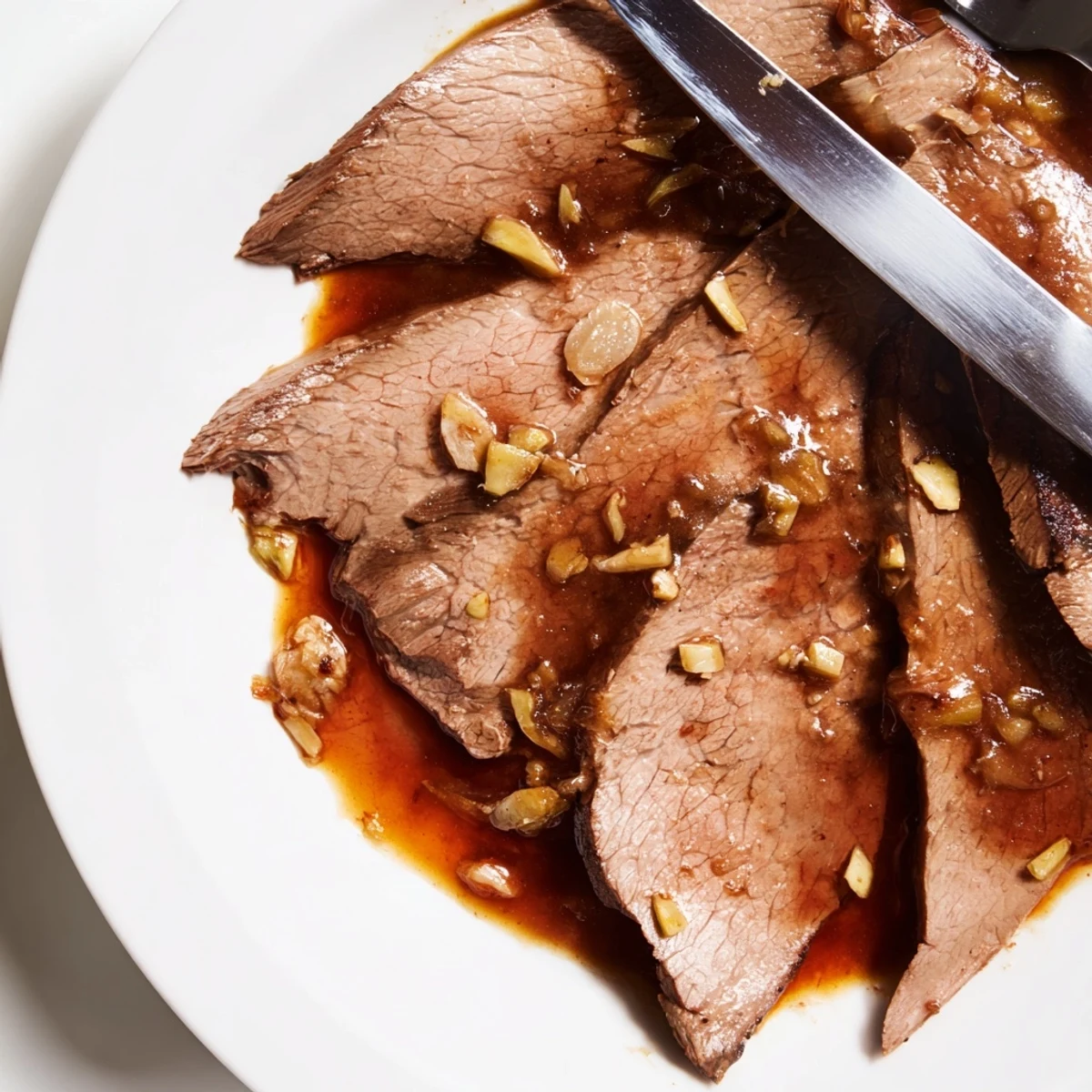 This slow cooker Mongolian Beef dish features thinly sliced beef coated in cornstarch, simmered with garlic and ginger in a glossy, aromatic sauce. 
