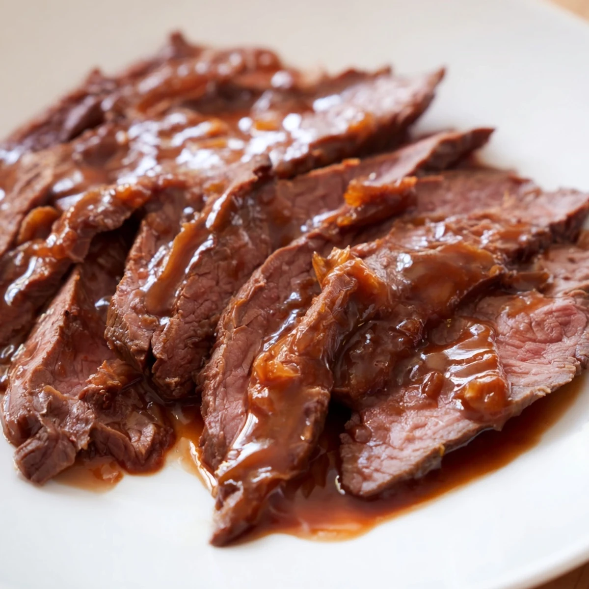 Ultimate Slow Cooker Mongolian Beef simmered in a rich, sweet-savory sauce, garnished with sesame seeds and scallions in a rustic slow cooker.