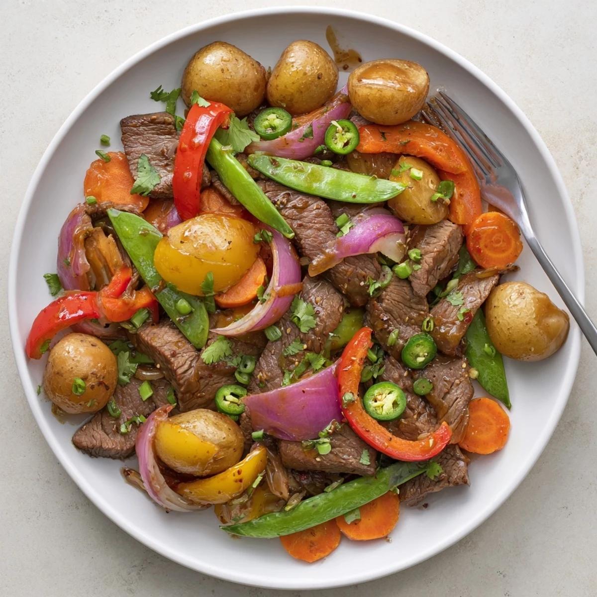 Sizzling beef and crisp veggies in Blackstone Cowboy Stir Fry Dinner, garnished with fresh cilantro and scallions.
