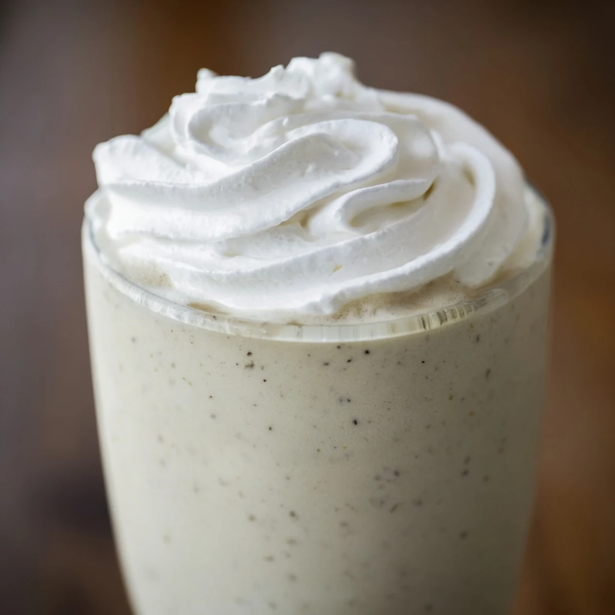 Chilled Starbucks Vanilla Bean Frappuccino served in a frosty glass with a straw.