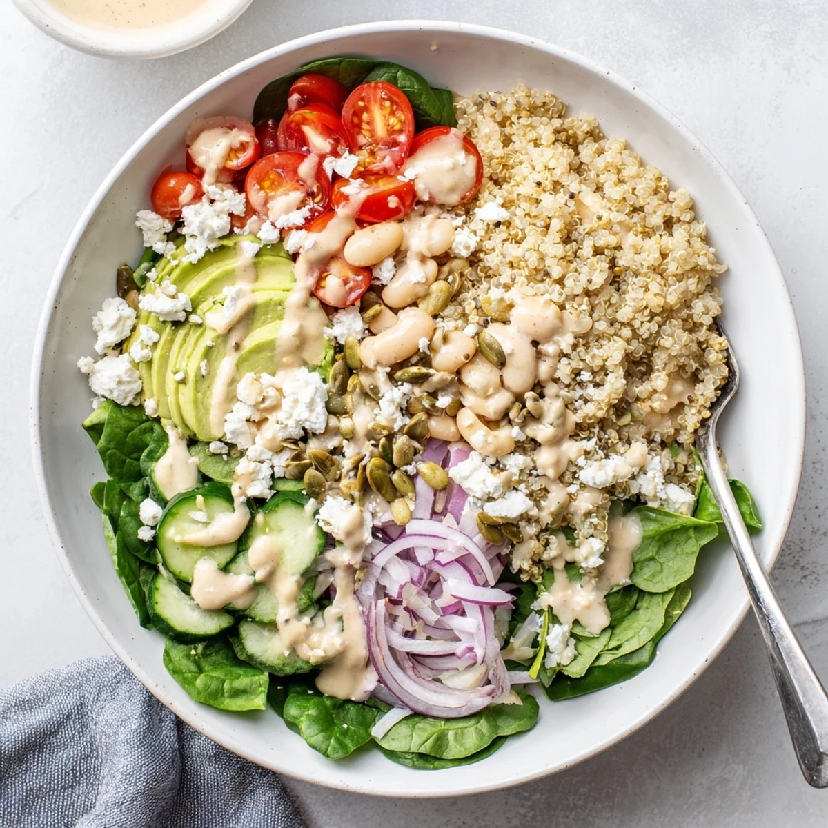 This nourishing Spinach & White Bean Ultimate Protein Power Bowl features fresh spinach, crunchy pumpkin seeds, and a satisfying lunch portion.