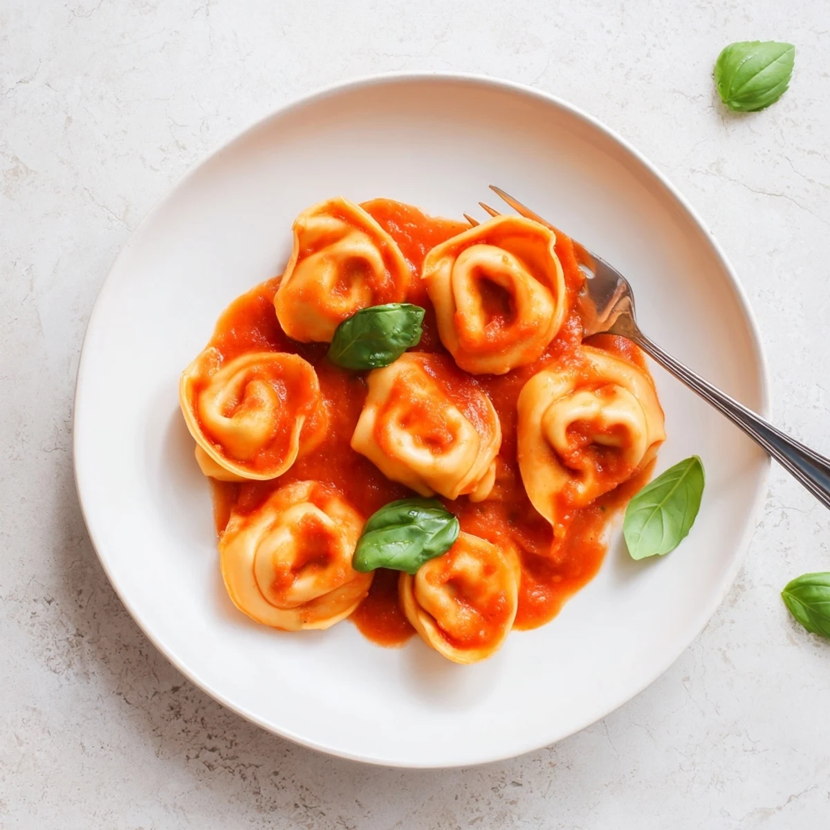 Freshly prepared Mozzarella Tortellini features tender pasta squares filled with creamy cheese, tossed lightly in garlic-infused tomato sauce and fresh herbs.