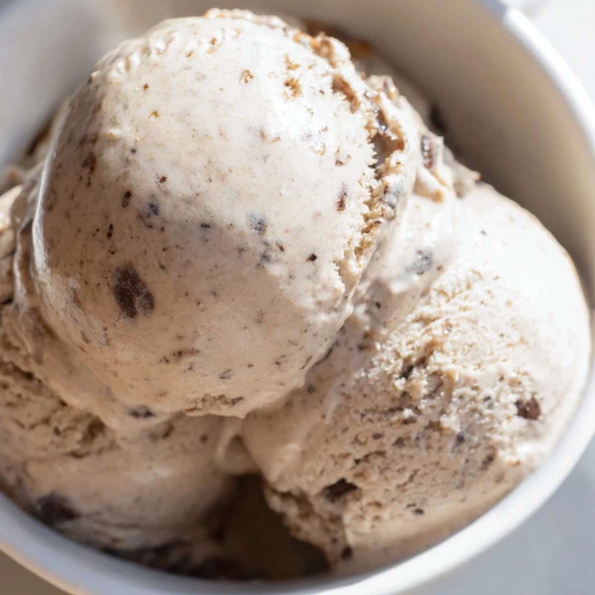 Vietnamese Coffee Ice Cream in a rustic ceramic dish, topped with crushed ice, evokes a refreshing cà phê sữa đá dessert.