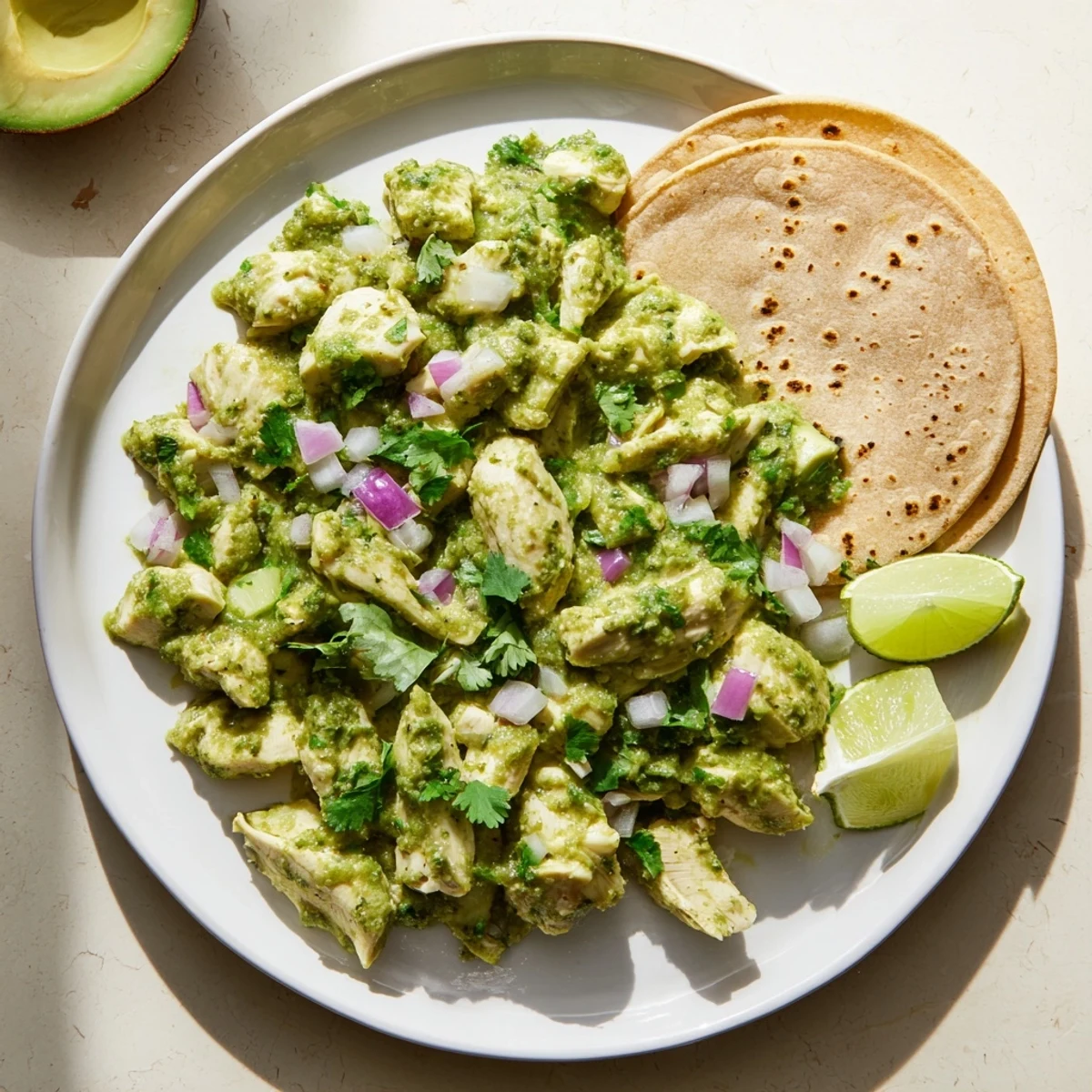 Golden chicken pieces simmered in tangy green salsa with fresh cilantro and diced red onion