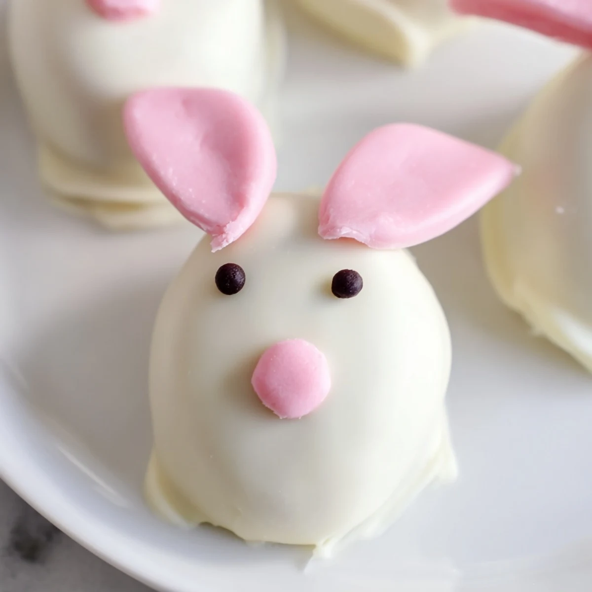 White chocolate Bunny Oreo balls decorated with marshmallow ears and cute pink details