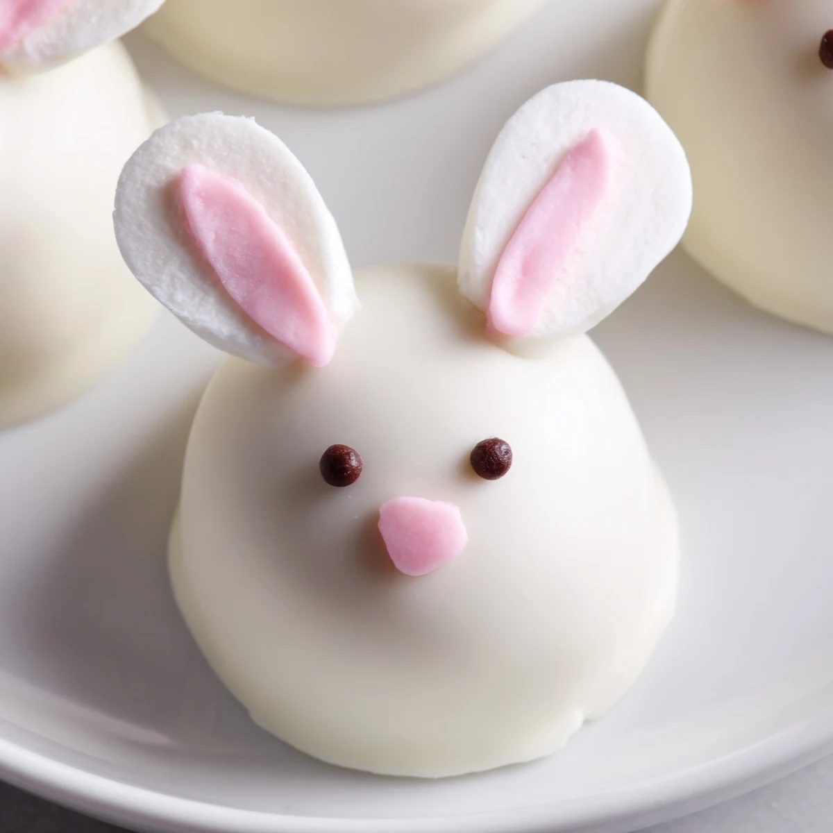 Chocolate-covered Oreo truffles shaped into adorable bunny faces with edible eyes and tails