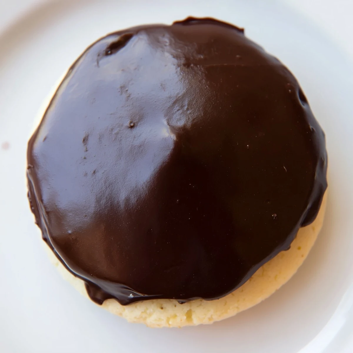 Golden vanilla cookie sandwiches piped with creamy custard and topped with glossy chocolate glaze