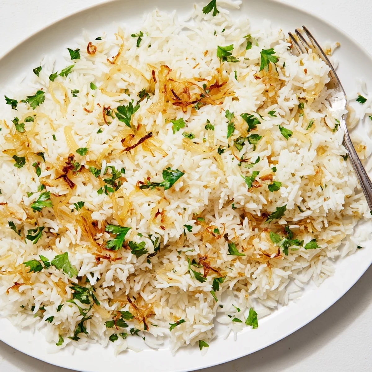 Golden French onion butter rice with caramelized onions and fresh parsley garnish