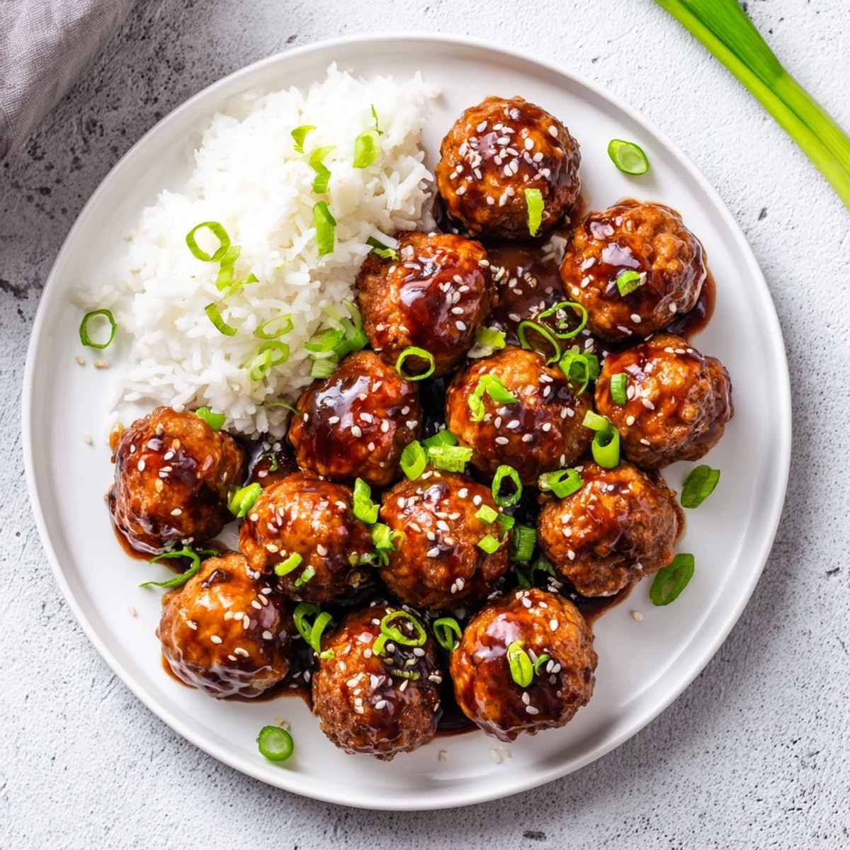 Japanese chicken meatballs simmering in a rich sweet savory teriyaki glaze ready for dinner