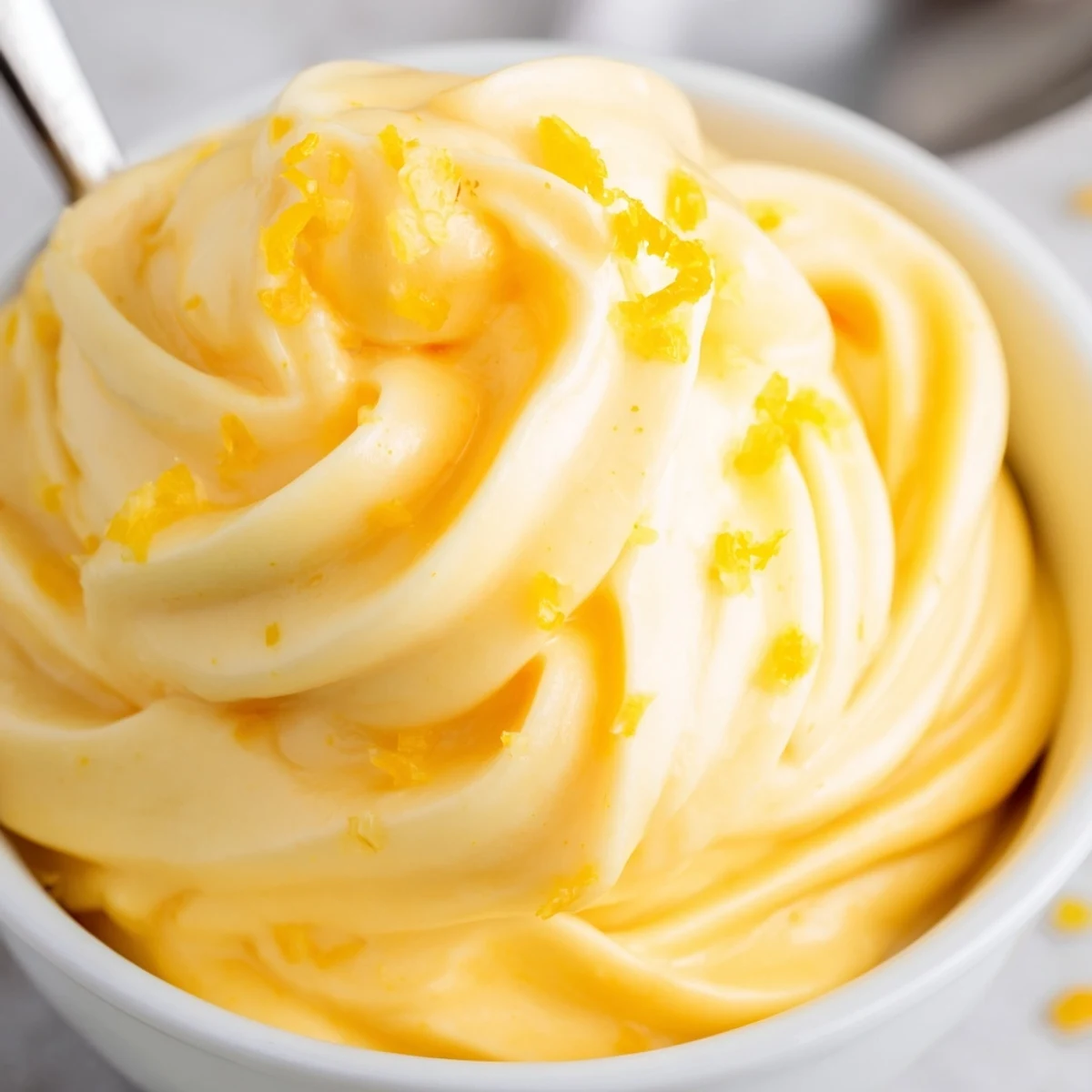 Bright orange homemade Dole Whip soft serve texture drizzled with extra honey topping