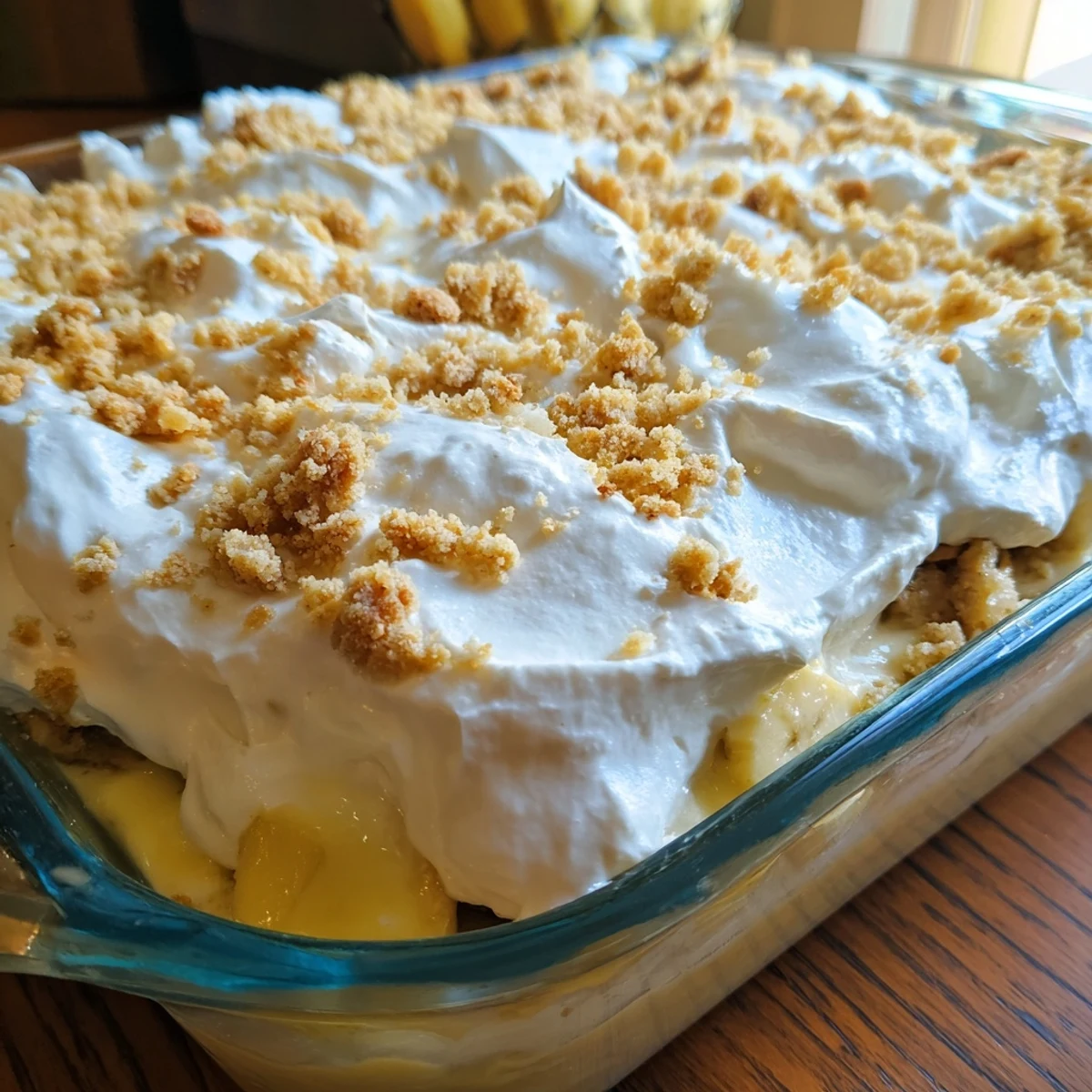 Rich creamy banana pudding cheesecake dump cake served warm with vanilla wafer cookie crumbles