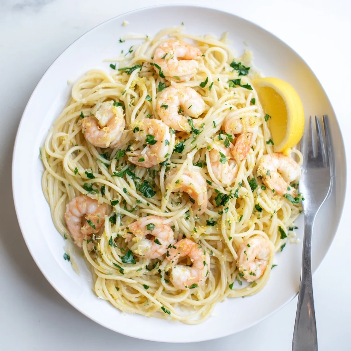 Twisted spaghetti pasta tossed with succulent pink shrimp and fresh parsley in a rich sauce