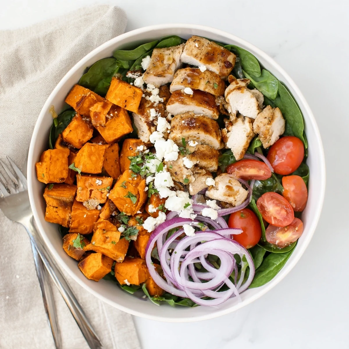Juicy chicken breast marinated in sweet maple syrup and Dijon mustard served over tender roasted sweet potatoes with cherry tomatoes.