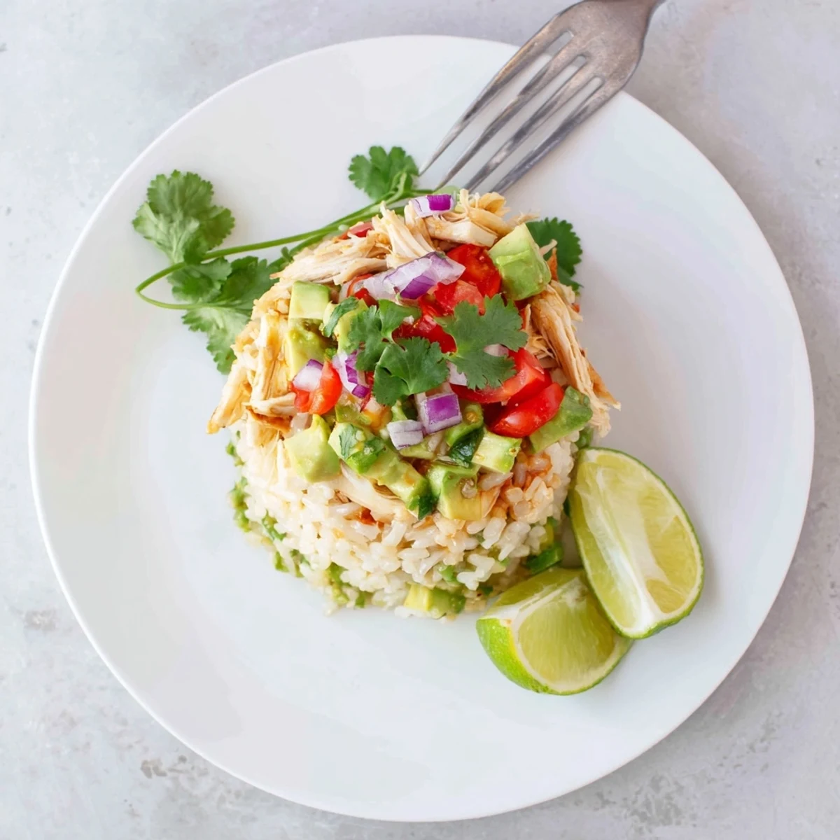 Layered honey lime chicken avocado rice stack featuring zesty glazed chicken and vibrant toppings
