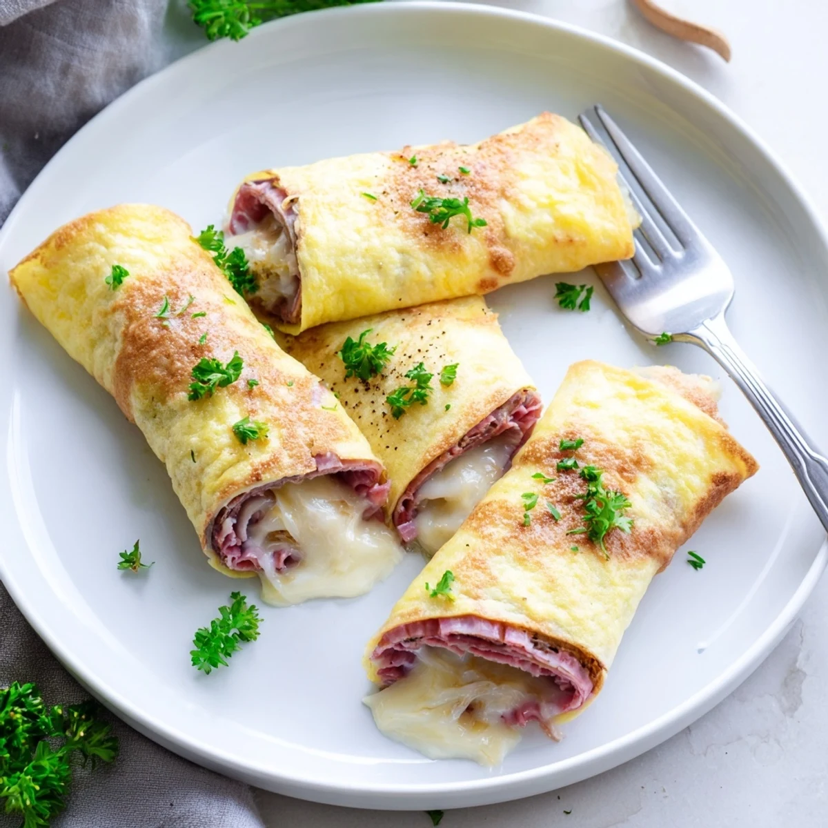 Tender egg-wrapped Low Carb Reuben Egg Roll Ups with tangy sauerkraut and creamy dressing