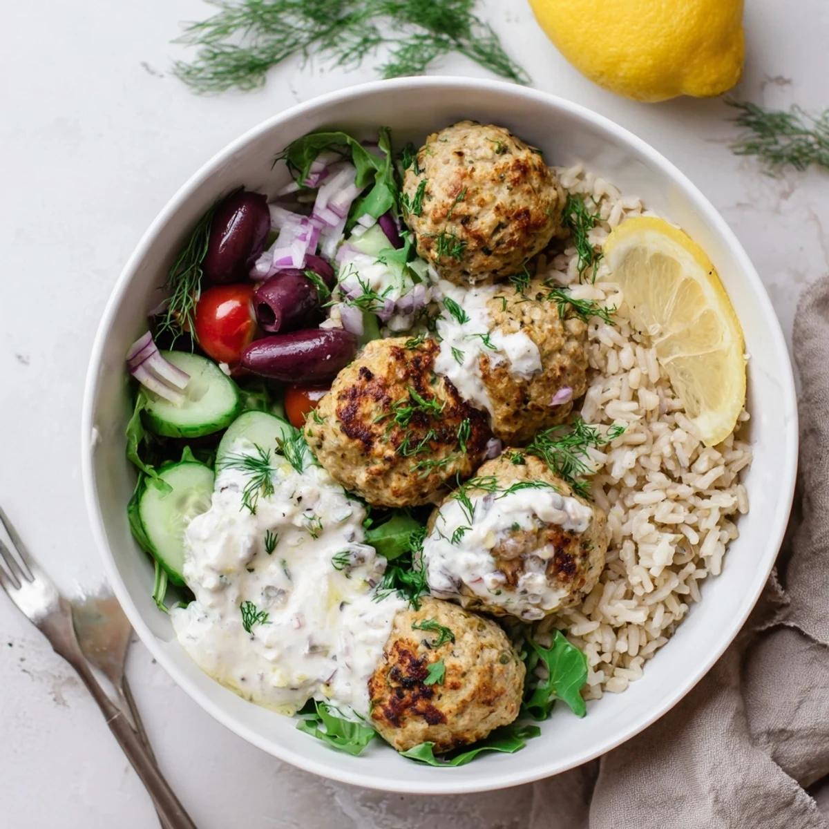 Turkey Mediterranean Meatballs Bowl with golden turkey meatballs, tangy yogurt drizzle.