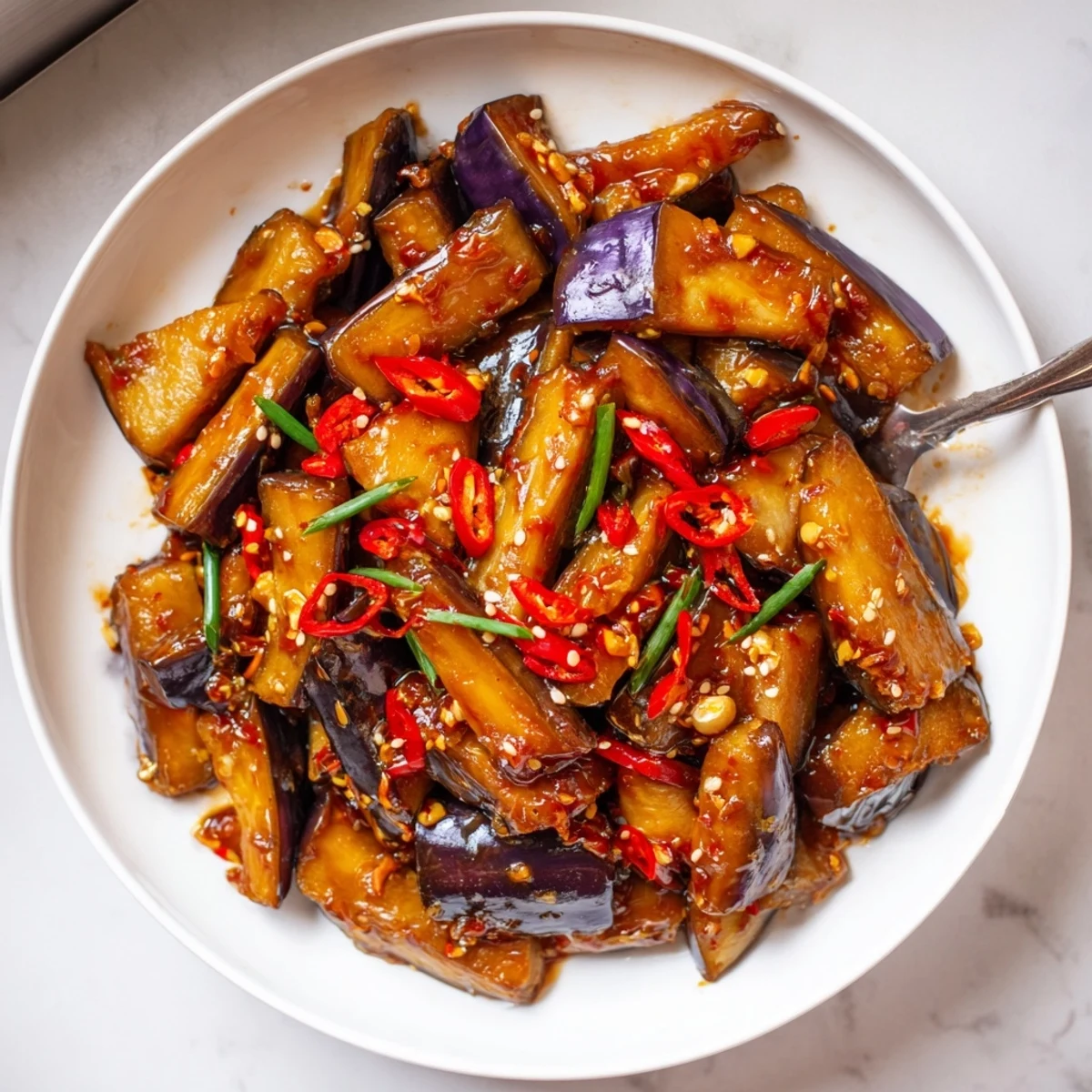 Warm Sichuan Style Braised Aubergines: tender, silky eggplant batons with fragrant garlic.