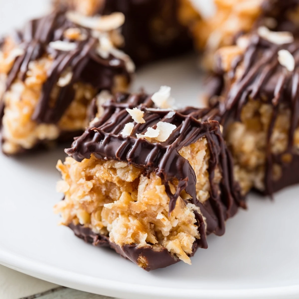 Bite-sized Samoa cookie treats layered with creamy caramel coconut and rich chocolate coating