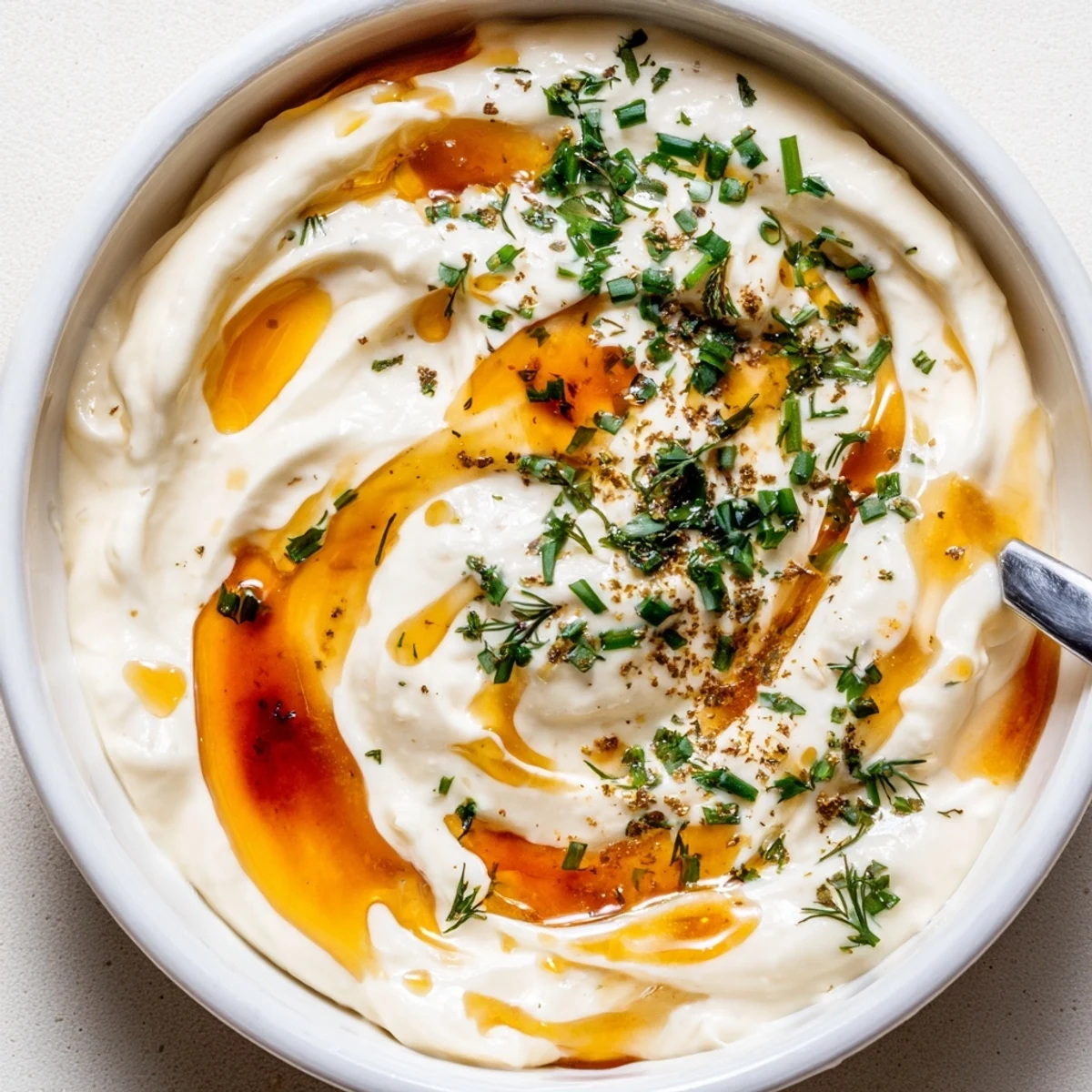 Creamy Hot Honey Ranch Dip with chives, honey sheen, served with veggies.  