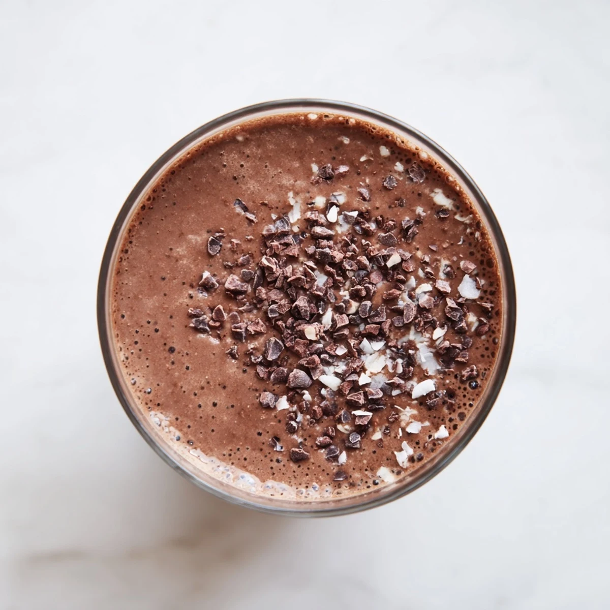 Creamy raw chocolate banana shake blending frozen bananas with rich raw cacao powder