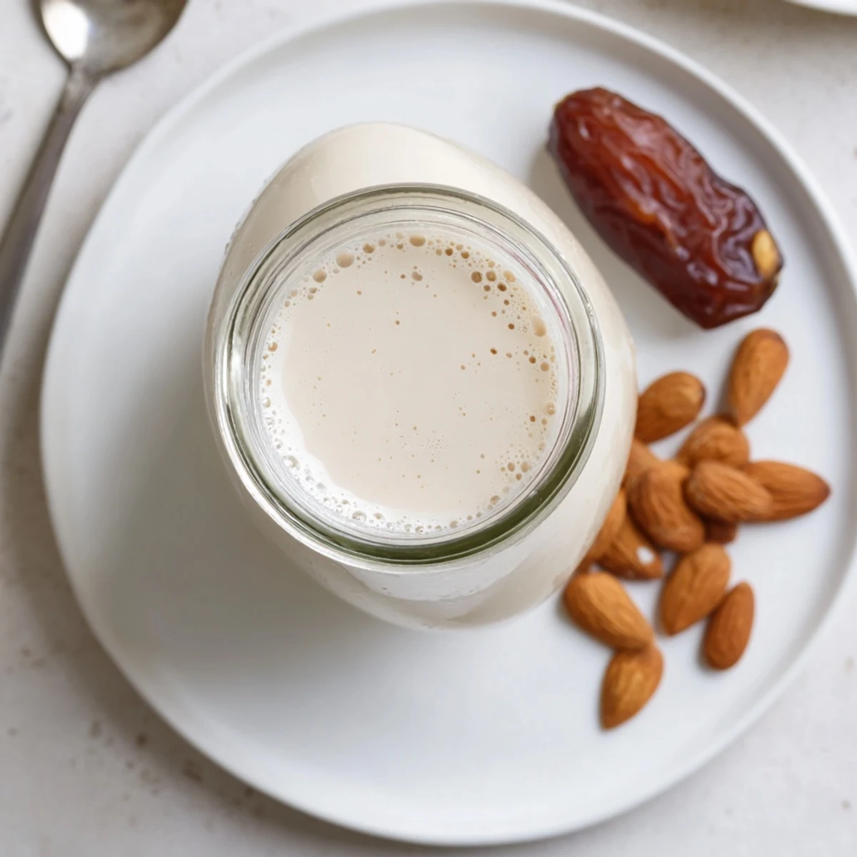 Creamy homemade Almond Milk in glass jar, perfect for coffee and cereal