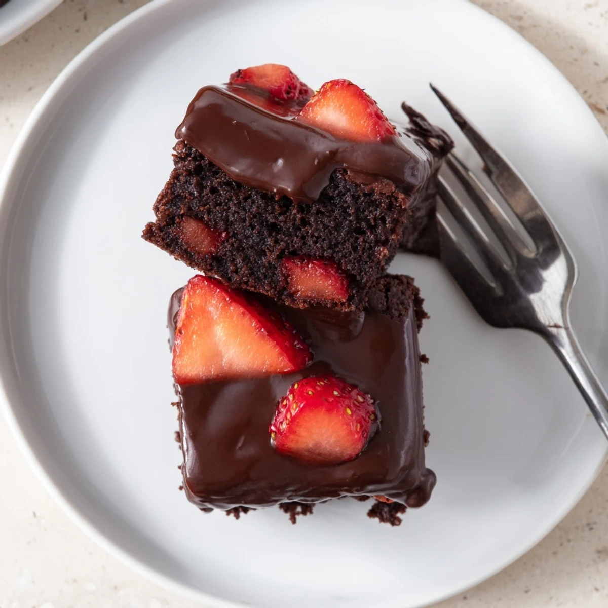 Chocolate Covered Strawberry Brownies with glossy ganache drizzled over juicy ripe strawberries on fudgy squares
