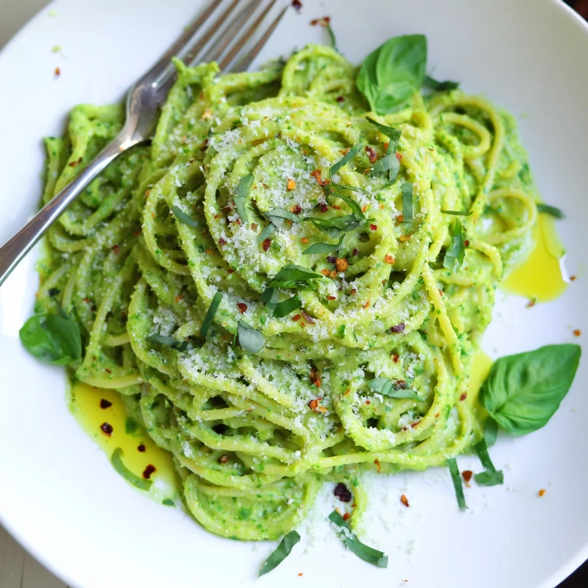 Smooth green goddess pasta sauce tossed with spaghetti and sprinkled with Parmesan cheese